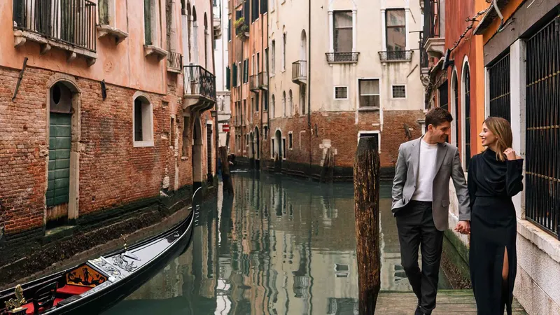 Photographer leading a couple through a quiet canal corner on a venice artistic photoshoot away from the crowds