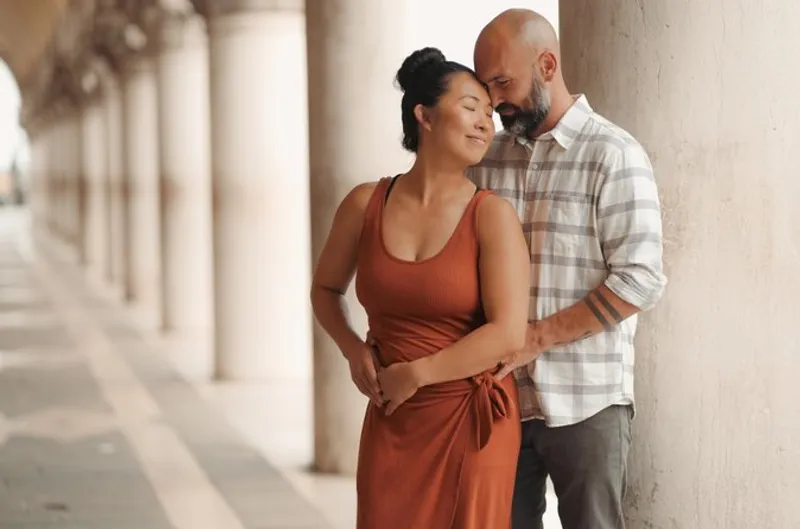 Couple embracing under the Doge's Palace arcade during a private photographer venice session